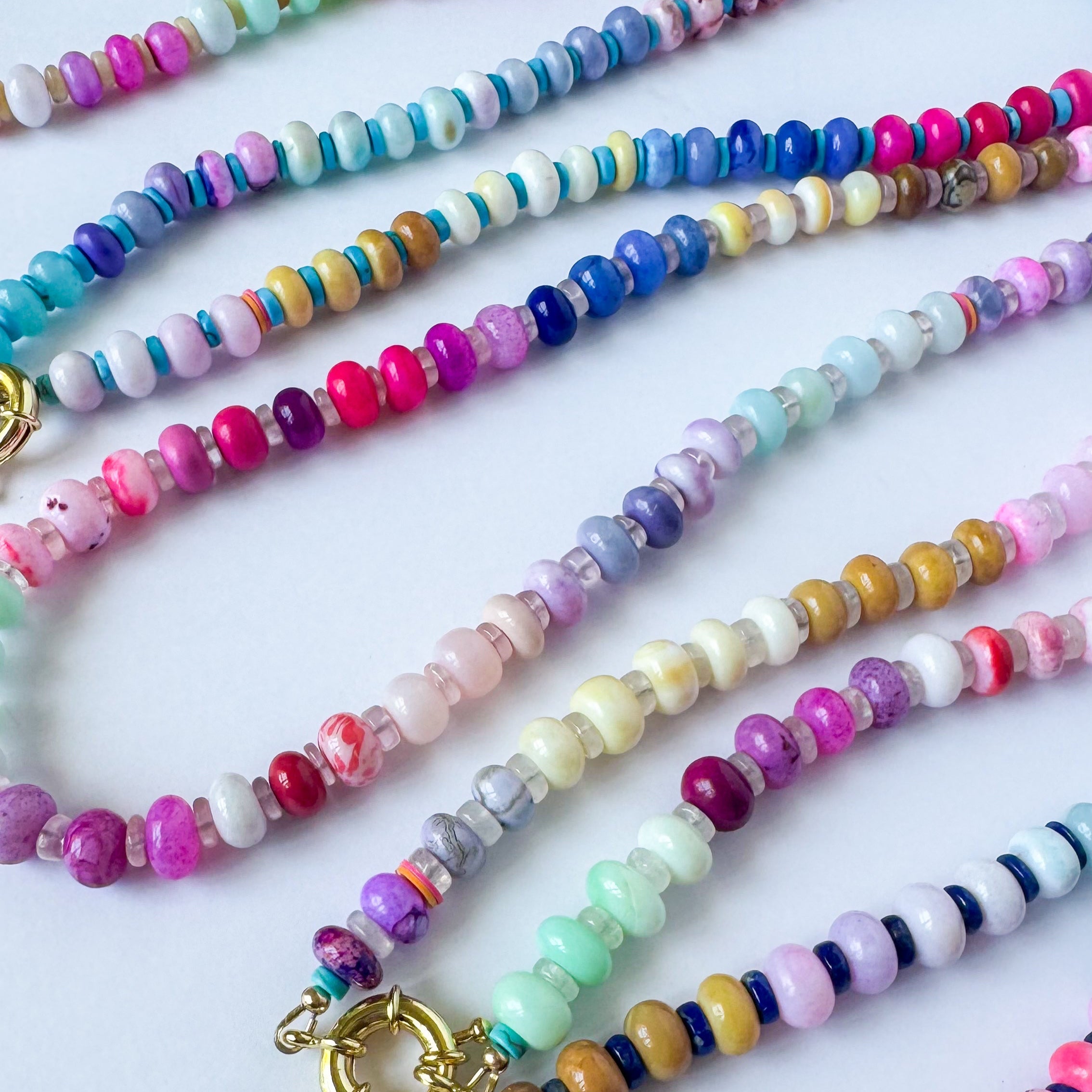 Colorful beaded necklaces on a white background
